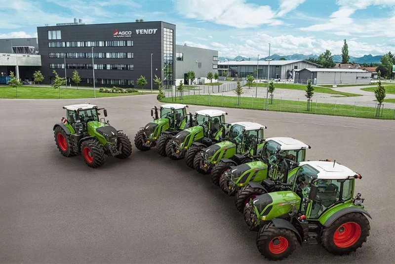 Lineup of Fendt tractors parked outside an AGCO Fendt dealership, showcasing the brand's advanced agricultural machinery and innovative design.